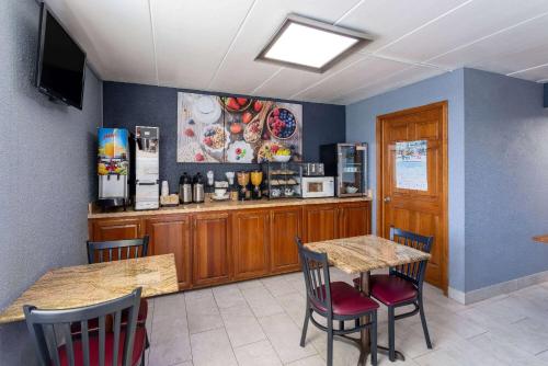a restaurant with a table and chairs and a counter at Days Inn by Wyndham Winchester in Winchester