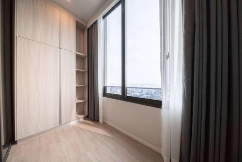 an empty room with a large window and a window sill at Ramada By Wyndham Bangkok Sukhumvit 87 in Bangkok