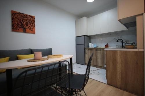 a kitchen with a table and chairs in a room at Enjoy Apartments Prilep in Prilep