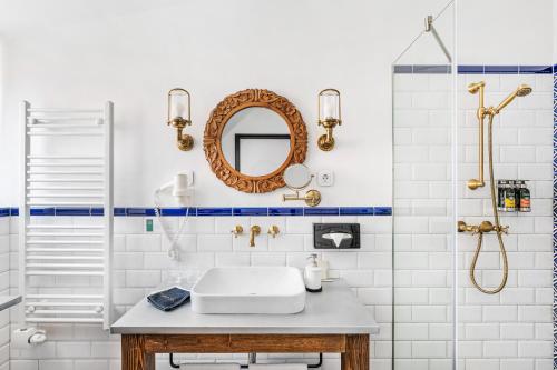 a bathroom with a sink and a mirror at Maison Bistro & Hotel in Budapest