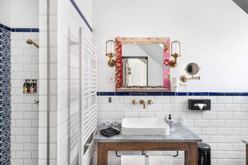 a bathroom with a sink and a mirror at Maison Bistro & Hotel in Budapest