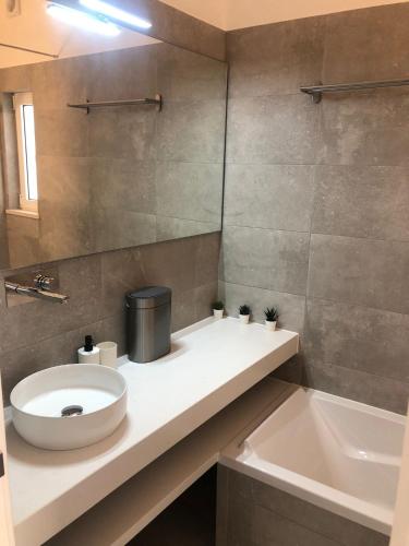 a bathroom with a sink and a toilet and a tub at Casa do Poço in Burgau
