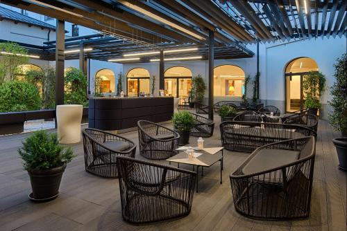 a restaurant with tables and chairs in a building at NH Collection Torino Santo Stefano in Turin