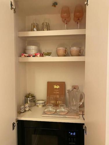 a kitchen with a shelf with bowls and a blender at Luxury Georgian Apartment - 5 Minute Walk to Spa in Bath