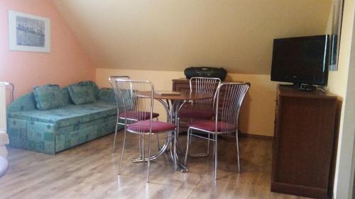 a living room with chairs and a table and a couch at Apartmán Ariana in Vrbno pod Pradědem