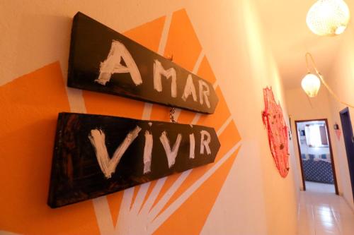 two signs on a wall with the words amar vim at Beach House Lanzarote in Arrecife