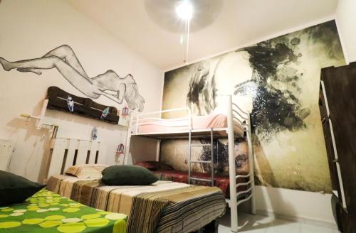 a room with two bunk beds and a painting on the wall at Beach House Lanzarote in Arrecife