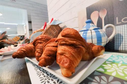 a plate of croissants and other pastries on a table at Beach House Lanzarote in Arrecife