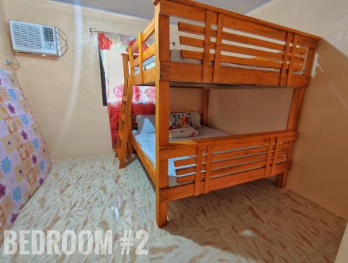 a bunk bed in a room with a bunk bed in a room at Patar White Beach Bolinao- Lilybeth's Transient House in Bolinao
