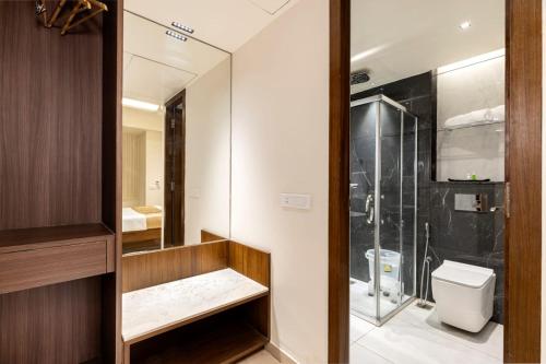 a bathroom with a shower and a toilet at Narthaki Boutique Hotel in Bangalore