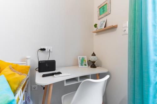 a desk in a room with a bed and a chair at Aiolos kolonaki vip apartment in Athens