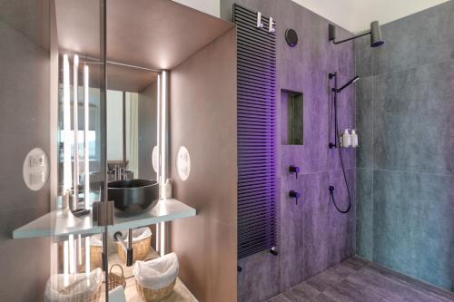 a bathroom with a walk in shower and a walk in shower at Arya Nobile Dimora in Carovigno