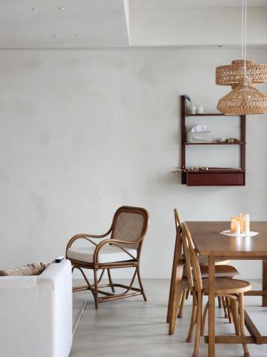 a living room with a table and chairs at Poolvilla Gaon in Busan