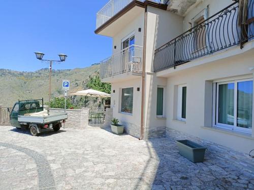 a house with a truck parked outside of it at Stanza Mylai Etna View in Castelmola