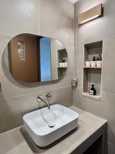 a bathroom with a white sink and a mirror at Poolvilla Gaon in Busan