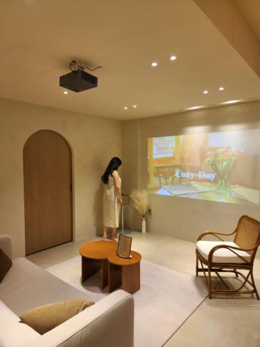 a woman is standing in a living room at Poolvilla Gaon in Busan