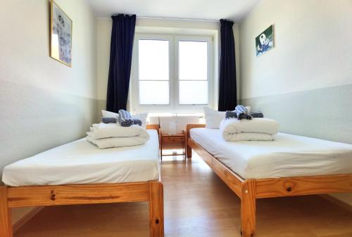 - 2 lits jumeaux dans une chambre avec fenêtre dans l'établissement Schaake Schillig Strandnähe, à Schillig