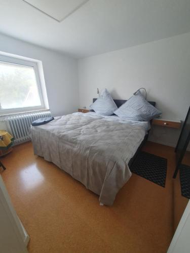 a bedroom with a bed in a room with a window at Haus zur Sonne in Lindenberg im Allgäu