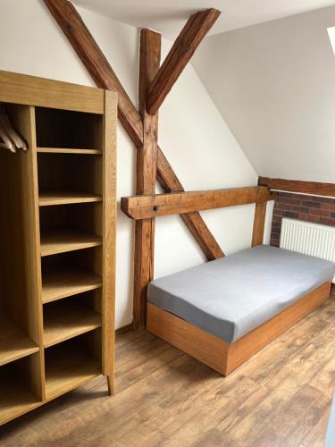 a bedroom with a bed and a book shelf at Penzión Pri Mlyne in Nitra
