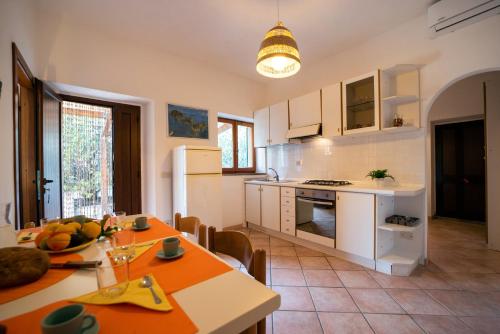 a kitchen and dining room with a table and chairs at Da Angiolina in Marciana
