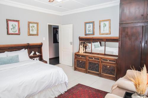 a bedroom with a large bed and a mirror at The Afropolitan in Johannesburg