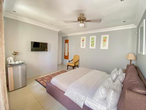 a bedroom with a bed and a couch at The Afropolitan in Johannesburg
