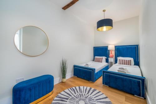 a room with two beds and a mirror at Stunning 3 Bedroom Duplex with Terrace in Brighton & Hove