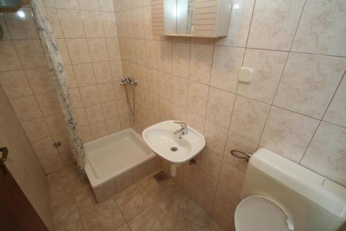 a bathroom with a toilet and a sink at Apartments Jerković in Stari Grad