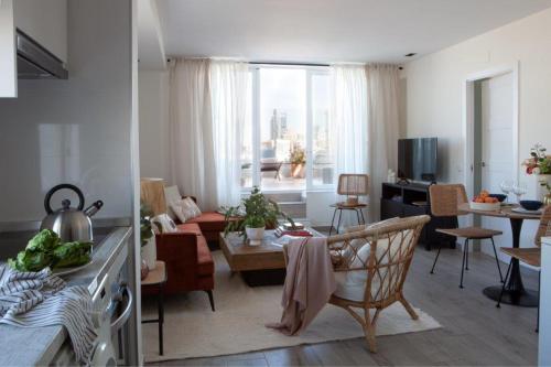 a living room with a couch and a living room with a table at Ático en Bernabéu con gran terraza, Paseo de la Castellana in Madrid