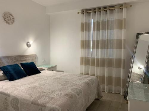 a bedroom with a large bed and a mirror at Sunset Avenida in Puerto de la Cruz