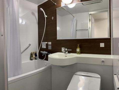 uma casa de banho com um lavatório, um WC e um espelho. em Hotel Alpha-One Kitashinsaibashi em Osaka