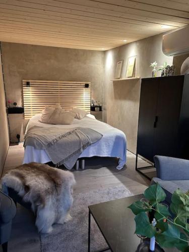 a bedroom with a bed and a dog in a room at Gamla stallet in Helsingborg