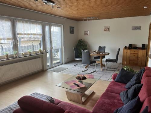 sala de estar con sofá rojo y mesa en An der Glocke en Plettenberg