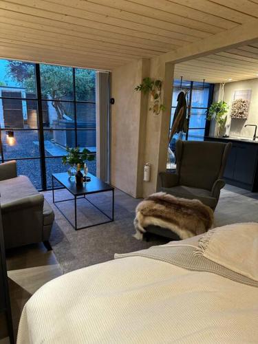 a bedroom with a bed and a living room at Gamla stallet in Helsingborg