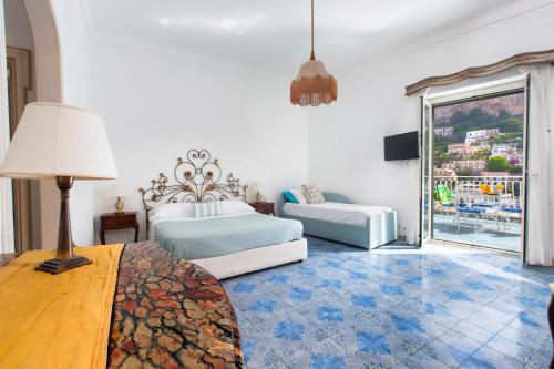 a bedroom with a bed and a table with a lamp at Estate4home- La casa del Maresciallo in Positano