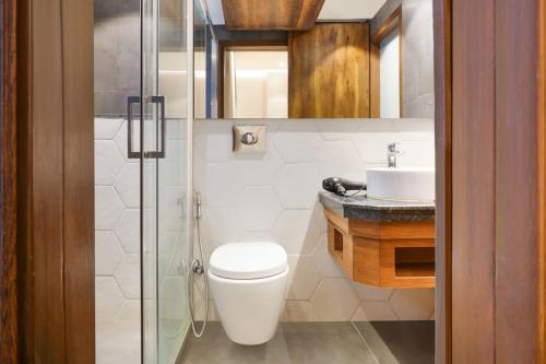 a bathroom with a toilet and a sink at Ultra Luxury Studio Apartment Elegant In Style in Gurgaon