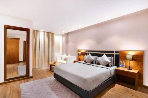 a bedroom with a large white bed in a room at Ultra Luxury Studio Apartment Elegant In Style in Gurgaon