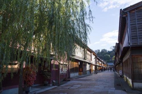 an empty street in an old town with a tree at Tmark City Hotel Kanazawa in Kanazawa