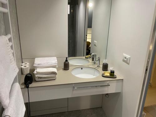 a bathroom with a sink and a large mirror at Torino48 Guesthouse in Milan