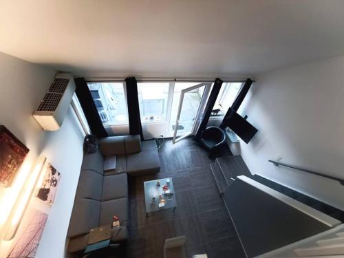 an overhead view of a living room with at Le Havre du Circuit / Triplex avec Sauna in Malmedy