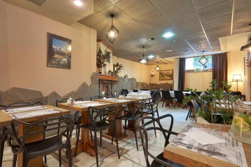 a restaurant with wooden tables and chairs in a room at Hotel Skalny in Zakopane