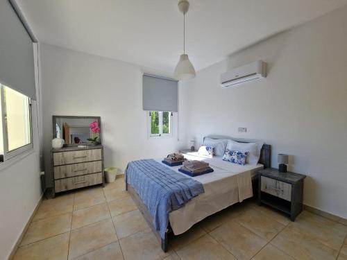 1 dormitorio con cama, tocador y espejo en Mandria, 3 bed with pool en Mandria