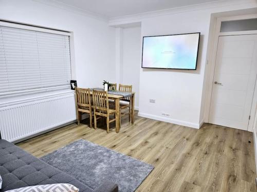a living room with a couch and a table at Wonderful Apartment in Wembley in London