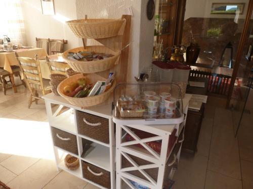 a white cabinet with baskets on top of it at Wein- und Gästehaus St. Aldegundishof in Sankt Aldegund