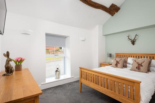 Ένα ή περισσότερα κρεβάτια σε δωμάτιο στο Cottage - Sleeps 4 hot tub & pet friendly