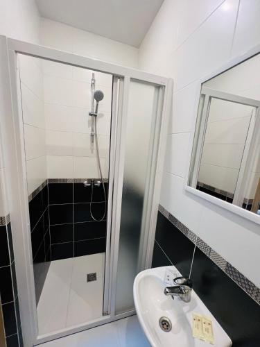 a bathroom with a shower and a sink at Vėjukai in Viduklė