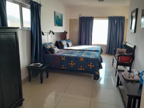 Postel nebo postele na pokoji v ubytování Umkomaas Lodge