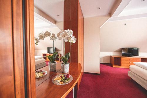 a hotel room with two plates of food on a table at PLAZA INN Recklinghausen in Recklinghausen
