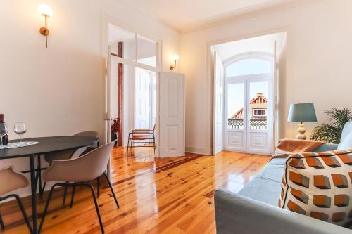 a living room with a table and a couch at Downtown Alfama & Me in Lisbon