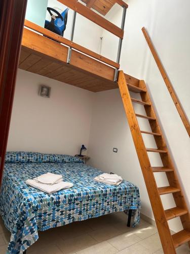 a bedroom with a bunk bed and a ladder at Stylish Loft Trivano Cagliari 2 beds/2 bath in Cagliari